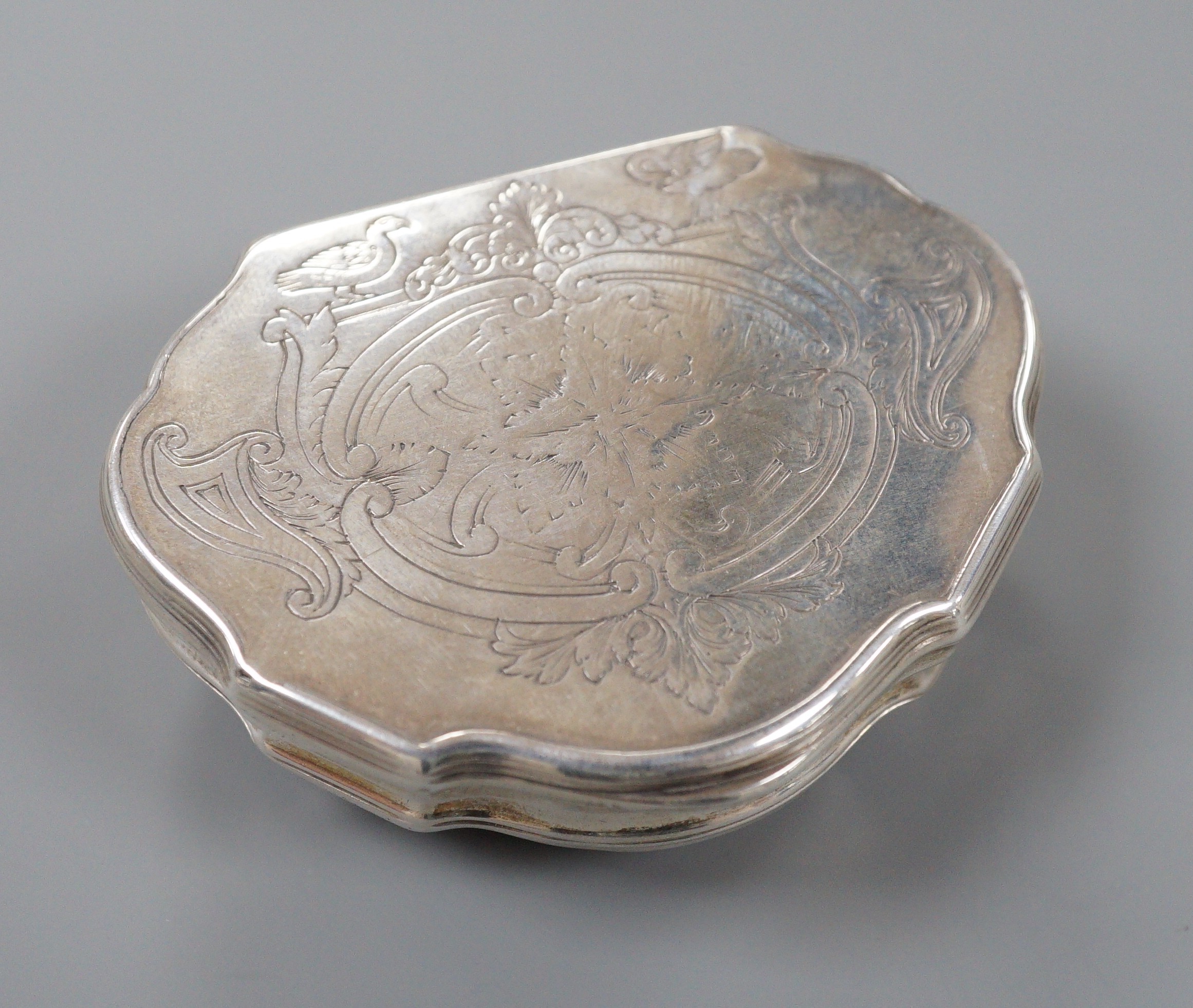 A late 18th/early 19th century white metal shaped demi-lune snuff box, makers mark, OR, 7cm, 69.5 grams.